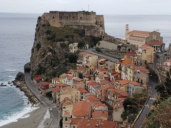 High angle view of buildings by sea