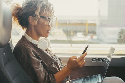 Side view of man using mobile phone