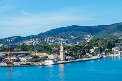 Scenic view of sea and buildings in city