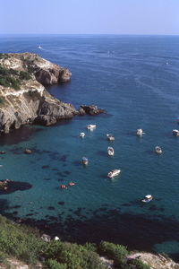 High angle view of sea and rocks against sky