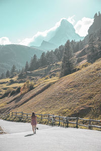 View of a women on the road to the mountains