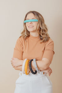 Portrait of a woman with a headband in her eyes and set of womens headbands in her hands. 