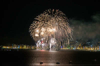 Low angle view of firework display against sky at night