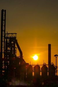 Silhouette of factory at sunset