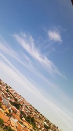 Built structures against blue sky and clouds