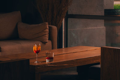 Man drinking glass on table at home