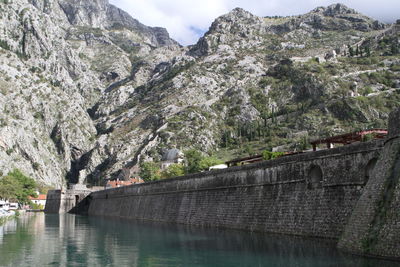 Bridge over river against mountains