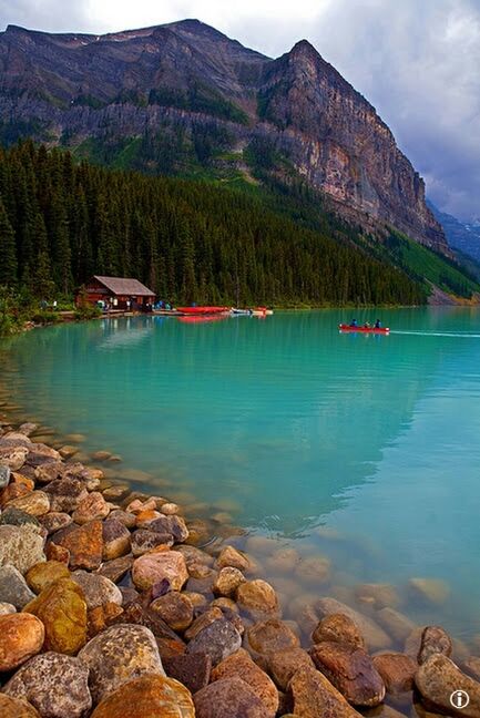 water, mountain, tranquil scene, tranquility, scenics, rock - object, lake, sky, nautical vessel, beauty in nature, nature, transportation, boat, idyllic, reflection, river, mountain range, day, rock, non-urban scene