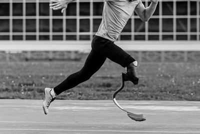 Full length of man skateboarding on field