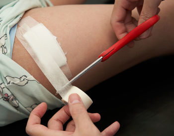 Midsection of doctor examining patient