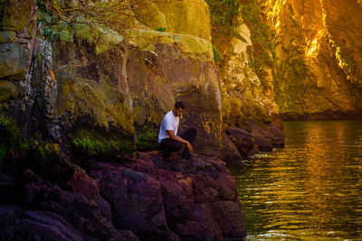 Man sitting on rock in cave
