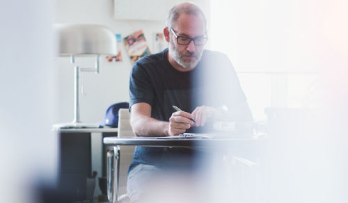 Portrait of man working on table