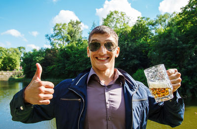 Portrait of smiling man drinking beer