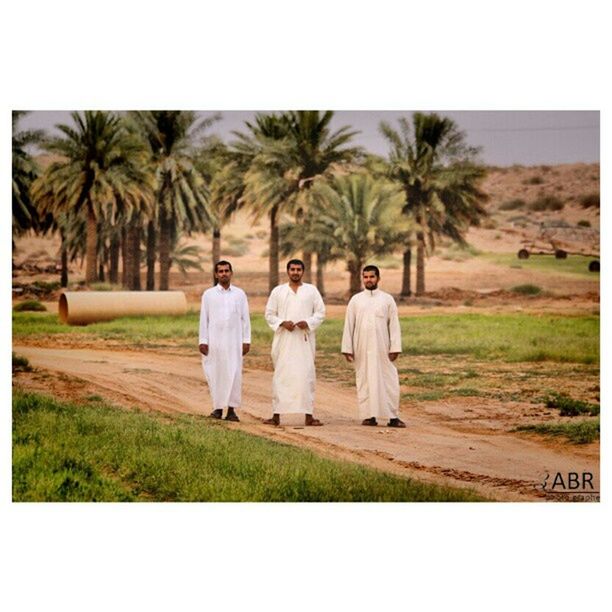 transfer print, lifestyles, togetherness, leisure activity, auto post production filter, full length, bonding, tree, rear view, casual clothing, men, grass, girls, person, walking, love, palm tree, field