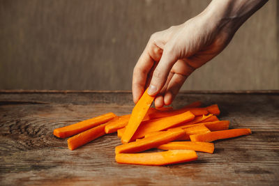 Cropped image of person preparing food on table