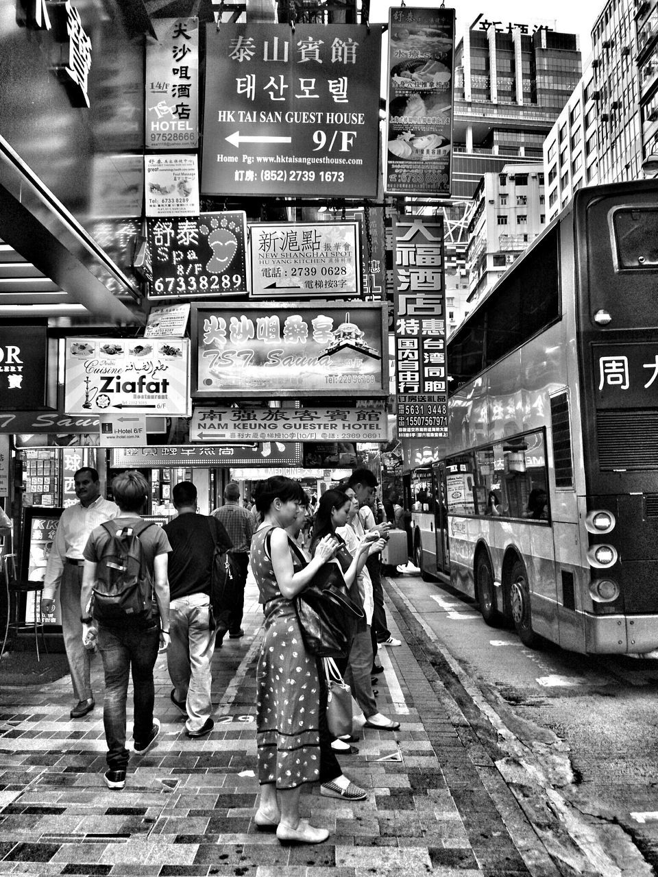 text, communication, western script, non-western script, architecture, built structure, men, building exterior, city, person, transportation, street, city life, information sign, walking, lifestyles, sign, large group of people, travel