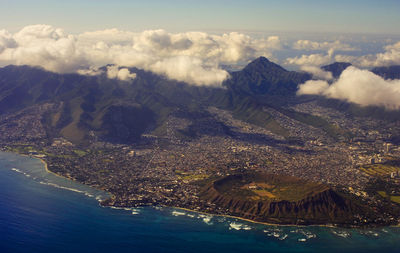 Aerial view of sea and cityscape against sky