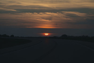 Scenic view of road against sky during sunset