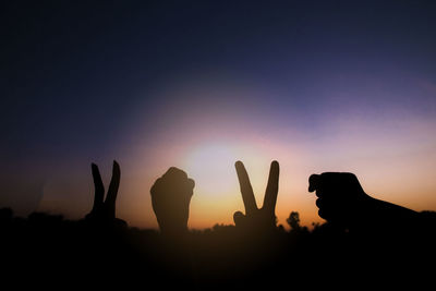 Silhouette of hands gesture v sign and fist power for victory/peace. success and winner in 2020.