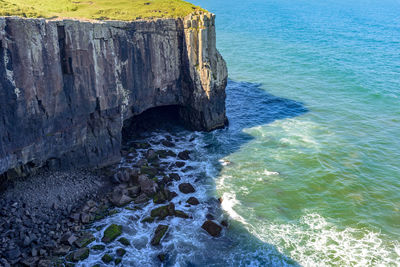 High angle view of rocks in sea against sky