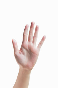 Close-up of cropped hand showing stop gesture over white background