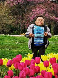 Full length of woman standing on tulips