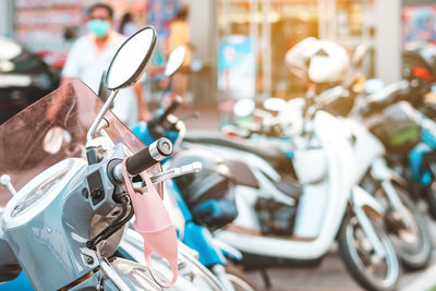 Close-up of face mask hanging on motorcycle