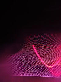 Abstract image of illuminated lighting equipment against black background