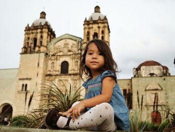 Low angle view of girl sitting at church