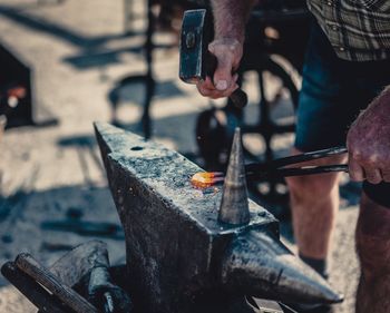 Midsection of blacksmith working