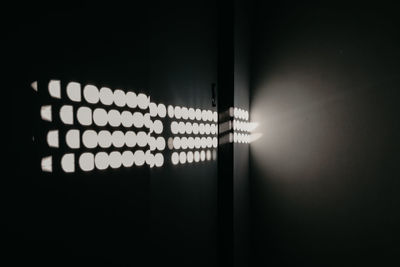 Close-up of illuminated light bulbs in dark room