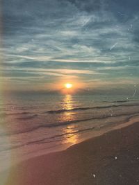 Scenic view of beach against sky during sunset