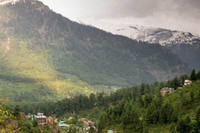 Scenic view of townscape against mountains