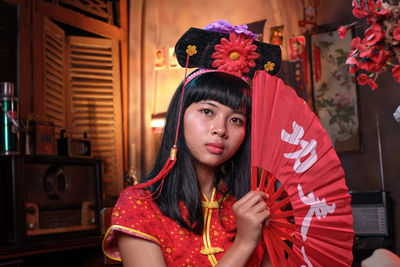 Portrait of woman with red flowers