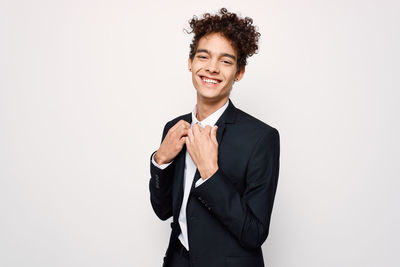 Portrait of smiling young man against white background