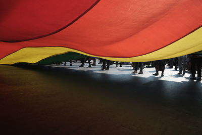 People walking on road with multi colored background