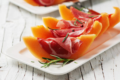 High angle view of chopped slices in plate on table