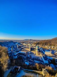 High angle view of townscape against clear blue sky