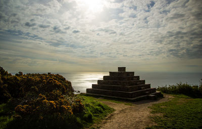 Built structure on beach against sky