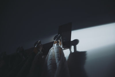 Low section of woman standing against wall