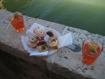 High angle view of food on retaining wall by lake