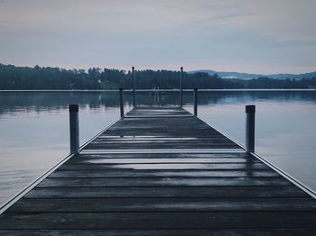 Pier over lake against sky