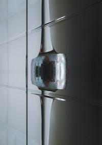 Close-up of wineglass on floor against wall