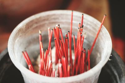 High angle view of incense sticks in container