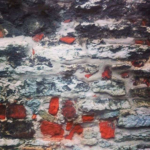 wall - building feature, red, high angle view, textured, rock - object, full frame, day, outdoors, wall, close-up, no people, weathered, backgrounds, nature, built structure, multi colored, water, paint, damaged, architecture