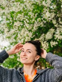 Portrait of a smiling young woman looking away