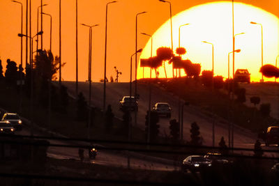 Silhouette city against sky during sunset