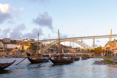 Bridge over river in city against sky