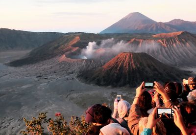 People photographing volcanic landscape