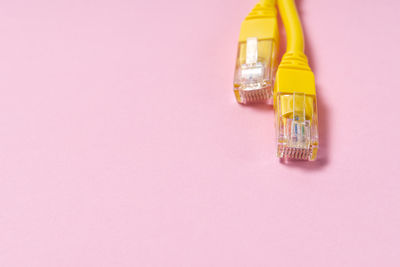 High angle view of electric lamp against pink background